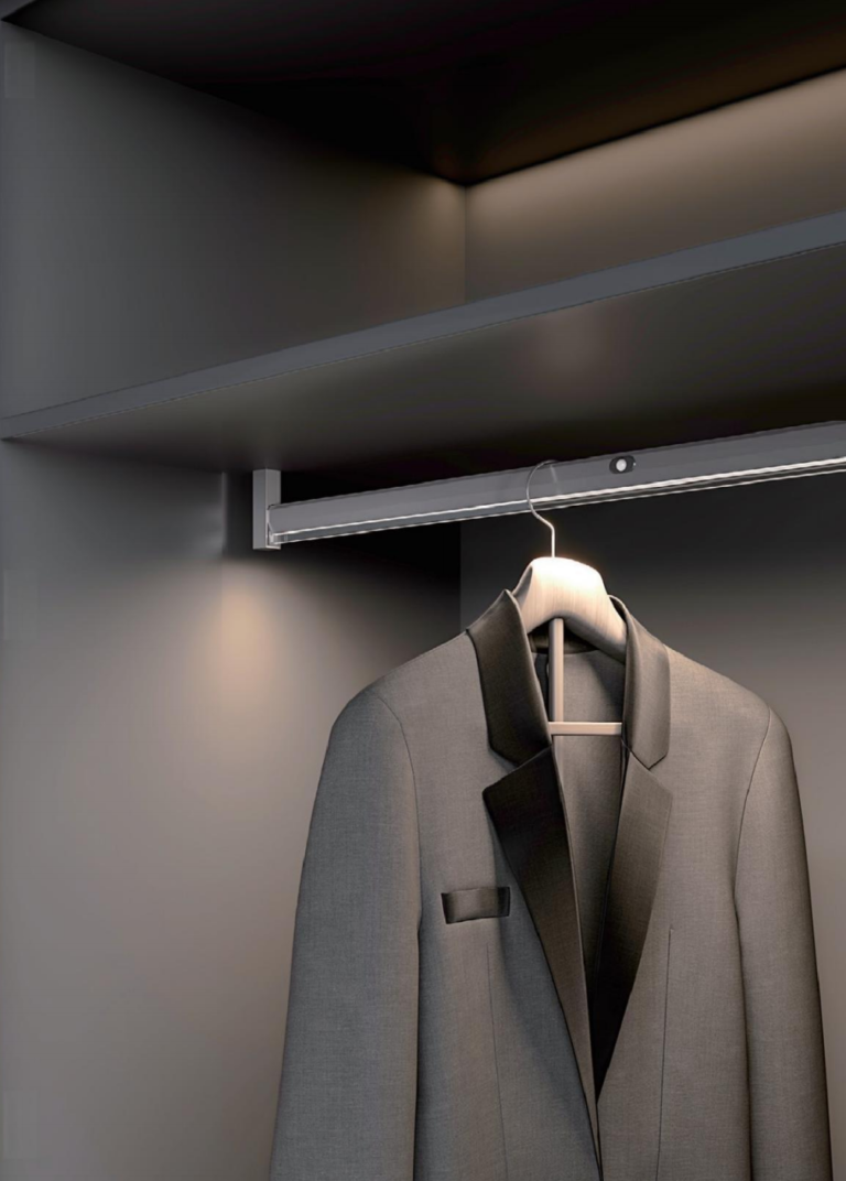 Concealed wardrobe lighting along a hanging rail with a sensor module